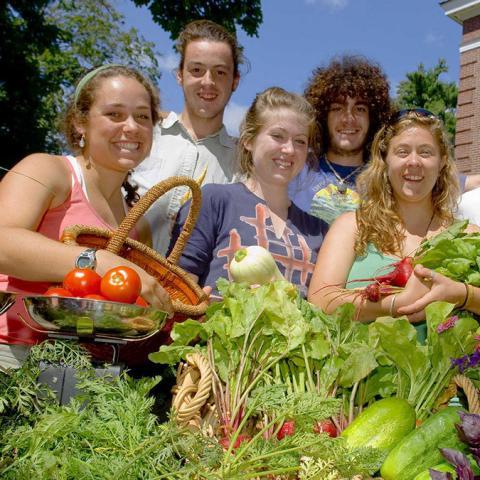 5 college students holding vegetables
