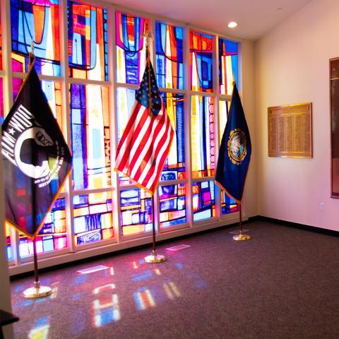 Memorial Room flags in front of stained glass window