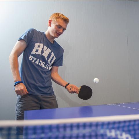 student playing table tennis
